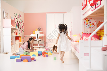 柔和混血儿享乐青年女人和两个女孩在卧室玩耍高清图片