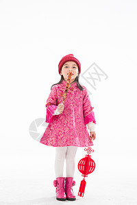 童年庆祝幸福欢乐的小女孩吃糖葫芦图片