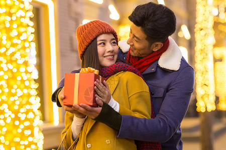 传统节日购物中心微笑青年情侣拿着礼物高清图片