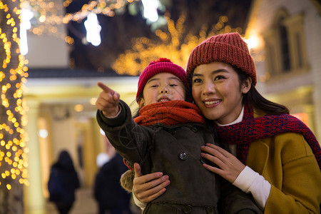 灯光下的妈妈围巾健康元旦快乐母女背景