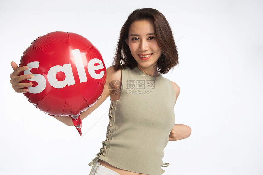 青春仅一个青年女人面部表情快乐的年轻女孩拿着气球图片