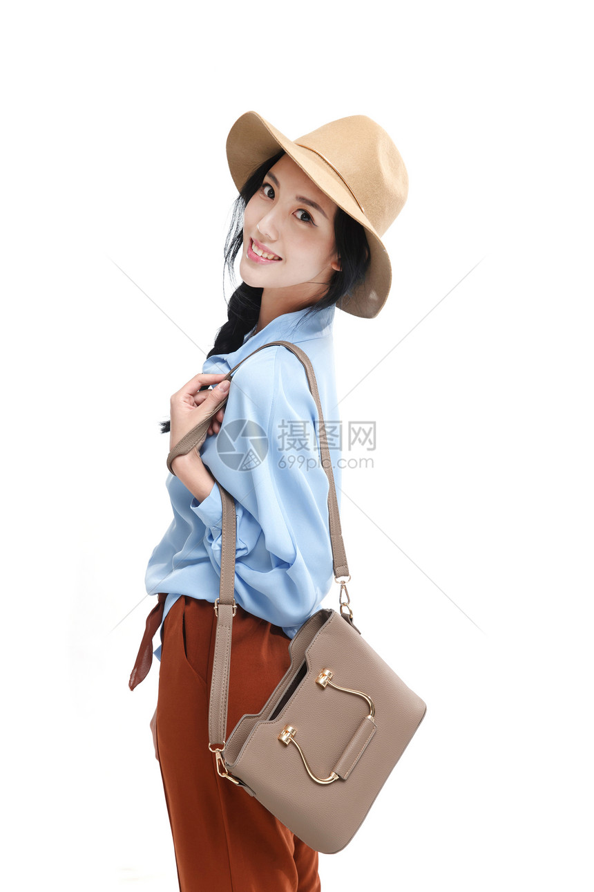 幸福帽子手提包漂亮的青年女人图片