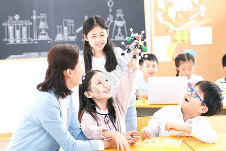 生物课程学龄儿童女教师和小学生在教室里背景