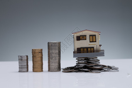 地产投资画册硬币货币创造力硬币和房屋模型背景
