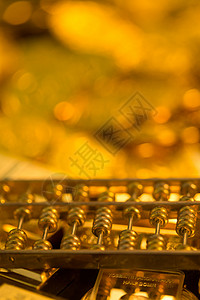 拟物古币金币金条黄金和算盘背景