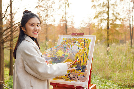 秋季户外女大学生公园写生背景图片