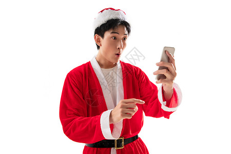 通讯圣诞帽年轻人穿圣诞服的青年男人拿着手机图片
