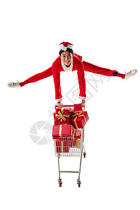 抢礼物青年人帽子礼品盒穿圣诞服的青年男人推着购物车背景