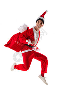 服装袋两腿分开20多岁圣诞帽穿圣诞服的青年男人背着礼物袋背景