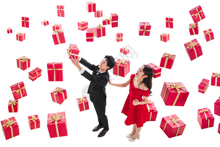 漂亮红色丝带高举手臂连衣裙节日伸手接礼物的幸福伴侣背景