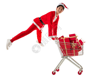 抢礼物乐趣20到24岁扭头看穿圣诞服的青年男人推着购物车背景
