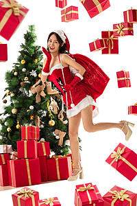 感享乐人穿着圣诞服的年轻女人和圣诞礼物图片