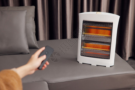 电暖器使用智能家居设备手部特写背景