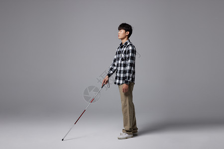 残疾人运动手拿盲杖的视障盲人形象背景