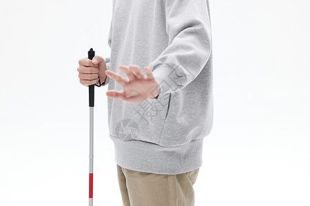 手握盲杖的视盲人士特写背景图片