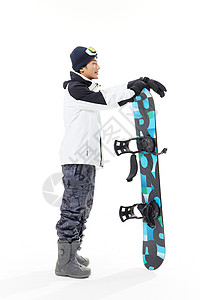 年轻男性拿着滑雪板背景图片