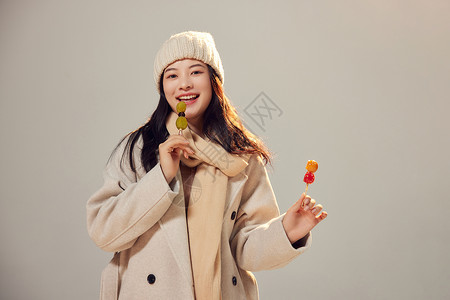 年轻美女冬季吃冰糖葫芦图片