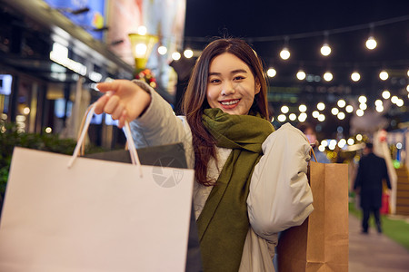 冬日女性夜晚逛街购物形象图片