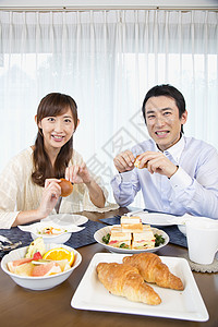 餐桌上吃饭的夫妻图片