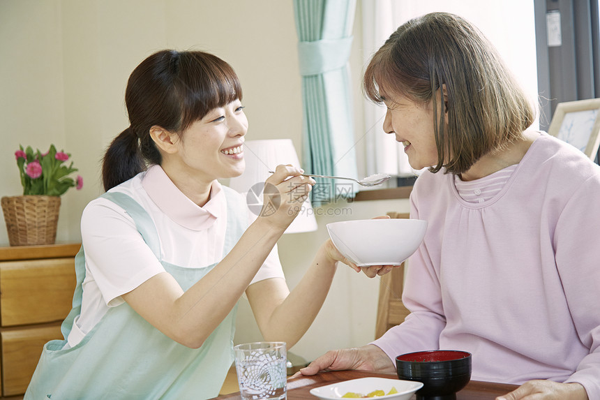 女性护工在照顾老人饮食图片