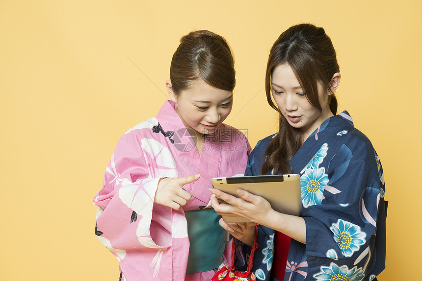 和服少女们在使用平板电脑图片