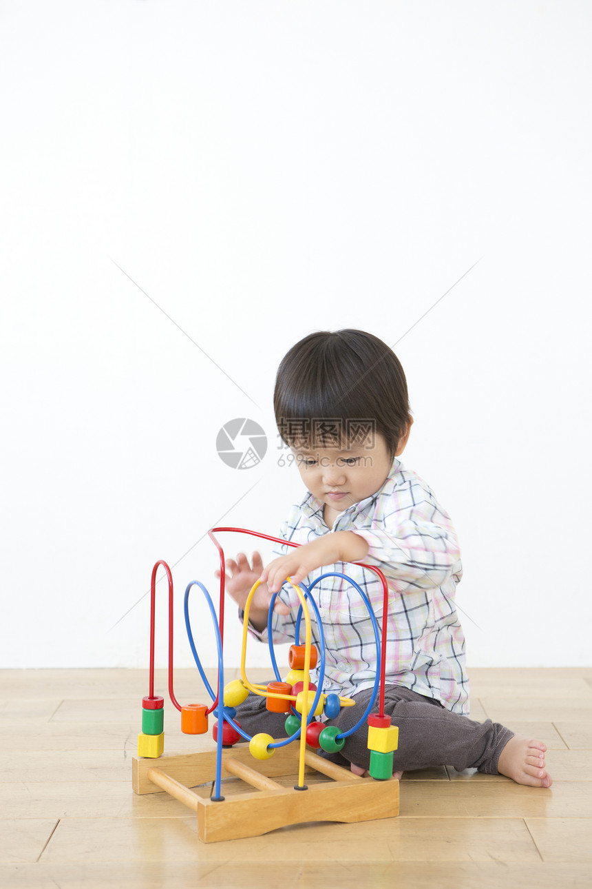 小男孩坐在地上玩玩具图片