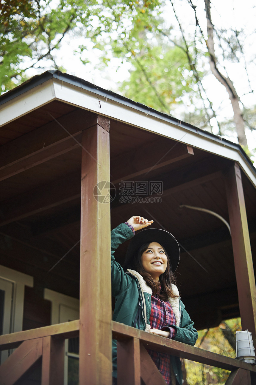 一个女人抬头看着小屋图片