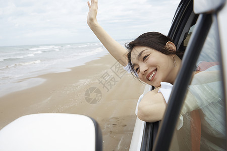 海边享受旅行的女青年图片