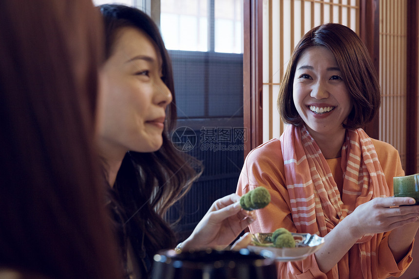 在金泽旅行的妇女品尝日式甜点图片