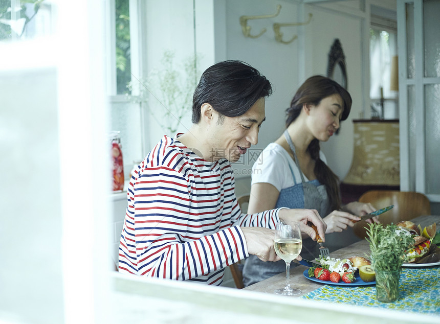 年轻情侣在户外野餐享受美食图片