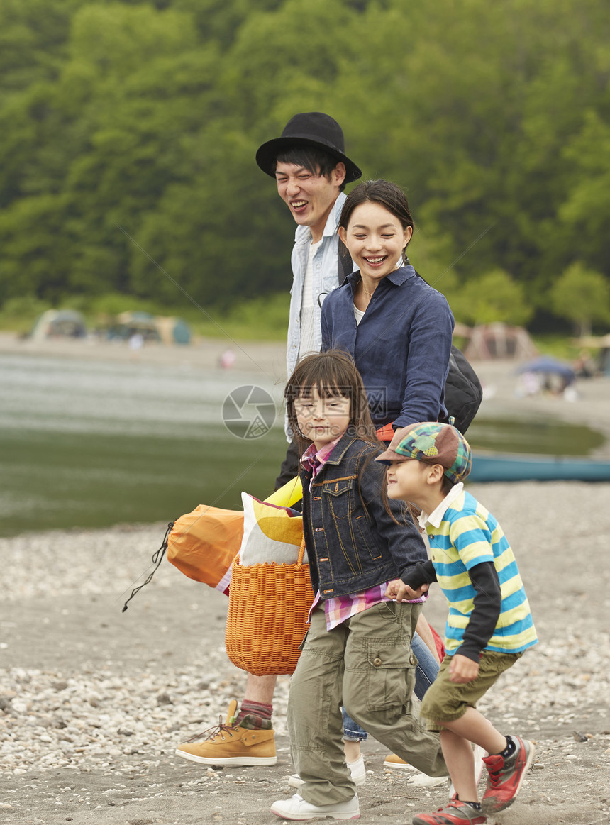 假期湖滨区露营玩耍的四口家庭图片