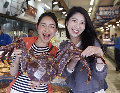 抓螃蟹的女孩海鲜市场女人抓大螃蟹背景
