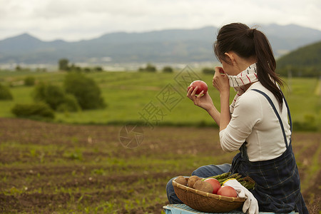 田间拿着农作物的农业女孩画像图片