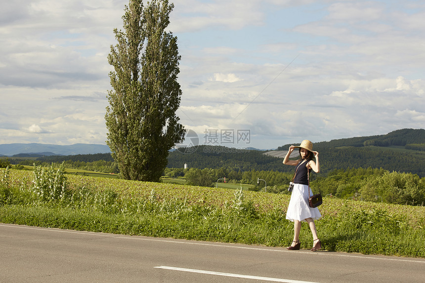 带着草帽肚子在乡间漫步的女人图片