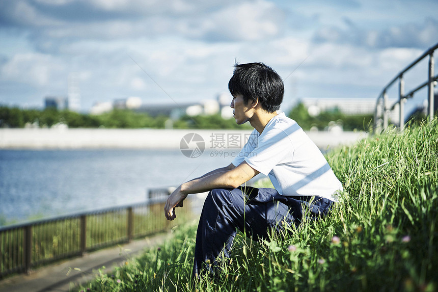 青年工匠在河边休息图片