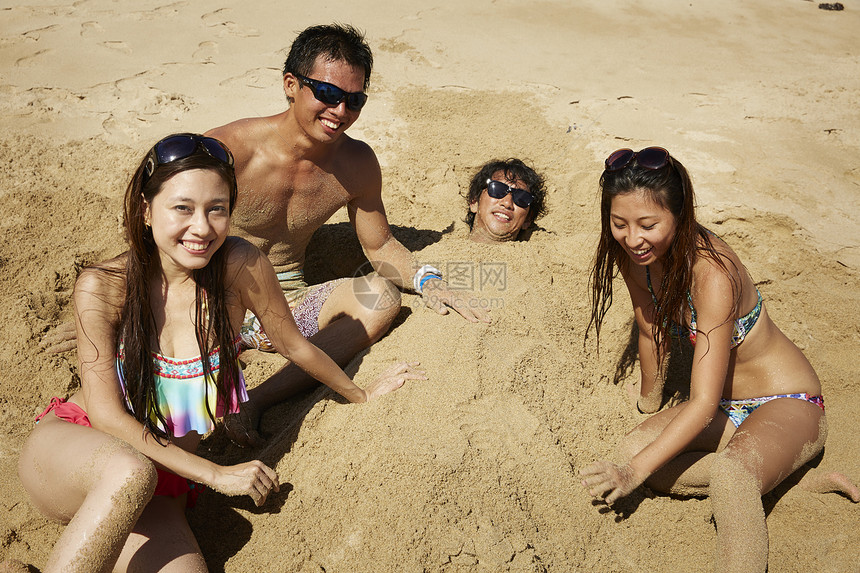 在沙滩上玩沙子的一群人图片