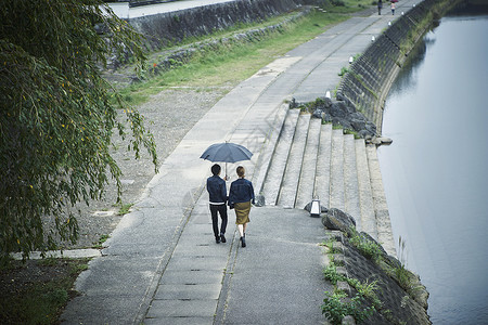 夫妇旅行雨中漫步照图片