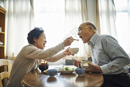 在吃饭的老年夫妻女人喂男人吃菜图片