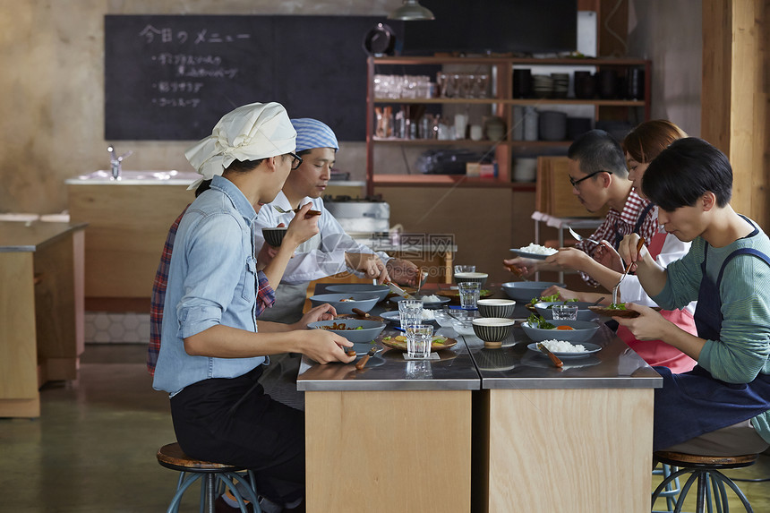 在学习烹饪的烹饪班成员在试吃图片