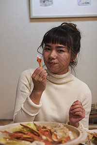 年轻女性开心的吃螃蟹高清图片