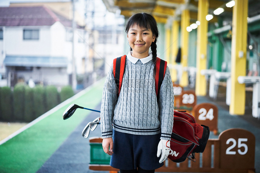 背着高尔夫球杆包的小女孩图片