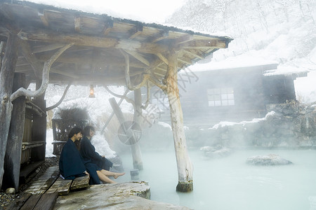 冬季雪天户外泡温泉的少女图片