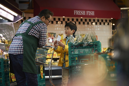 小男孩向超市职员咨询图片