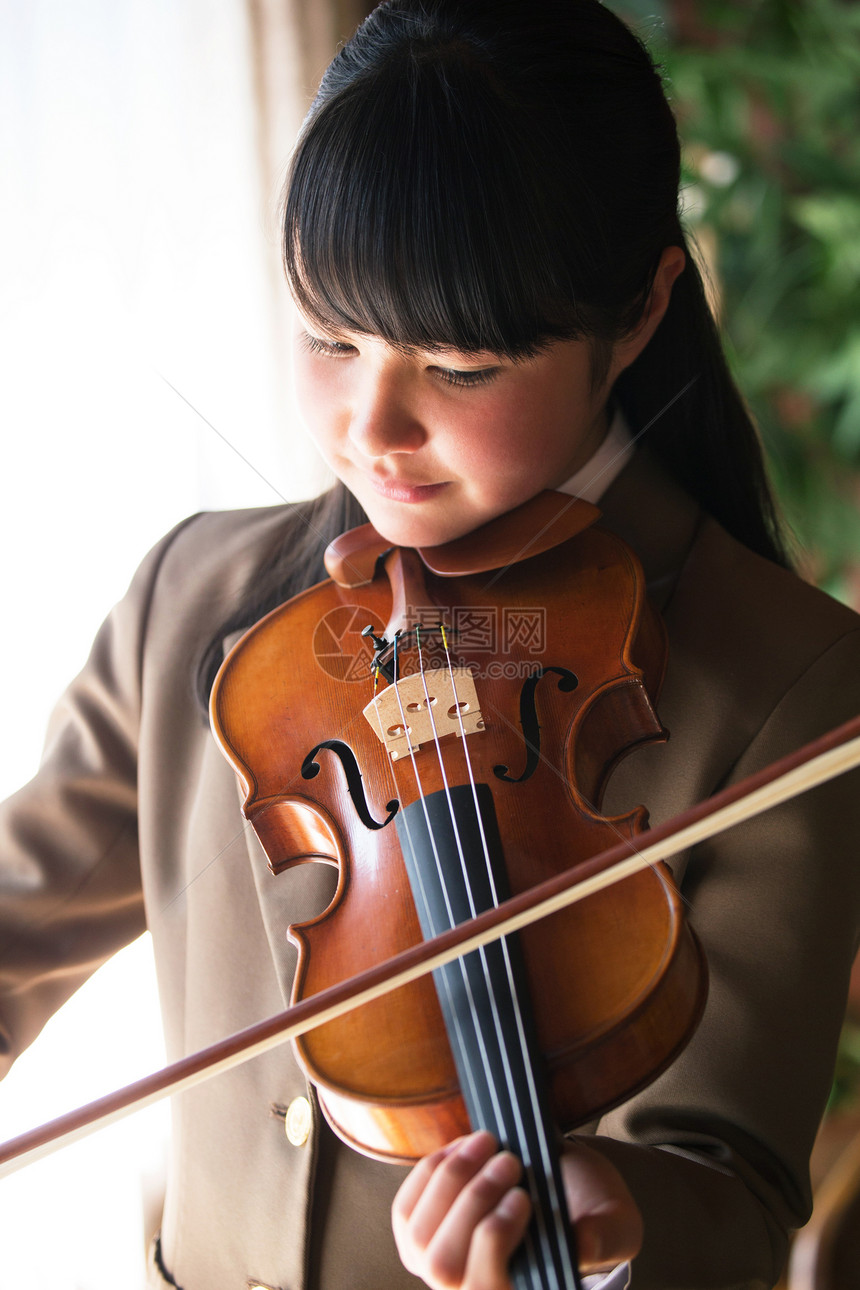 古典的制服女学生学习丰富的小提琴的女孩图片