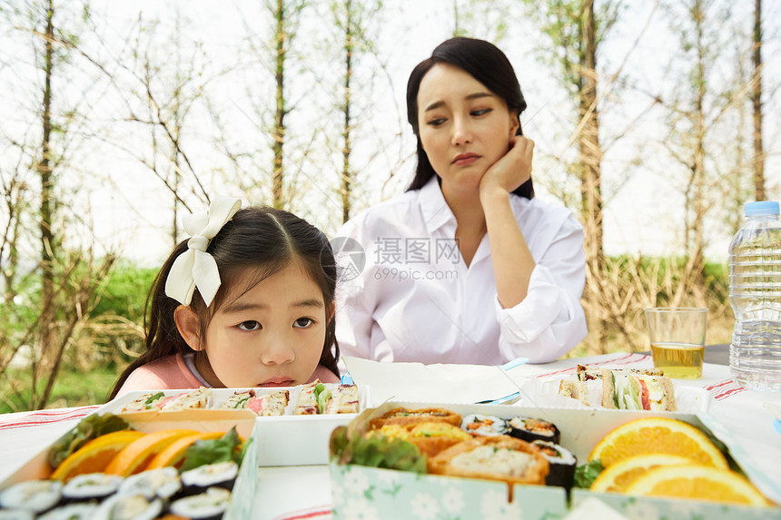 公园野餐不开心的女儿和母亲图片