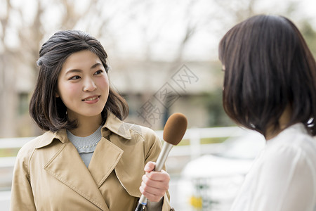 年轻女记者街头采访路人图片