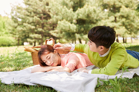 野餐垫上休息的年轻情侣图片