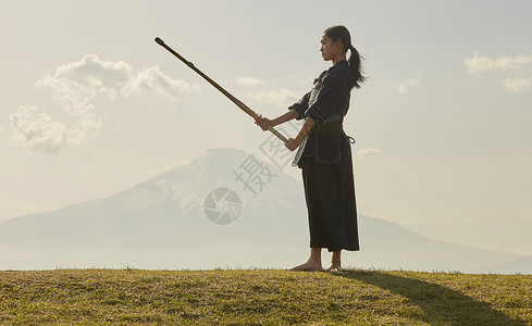 户外独自练习剑道的女孩背景图片