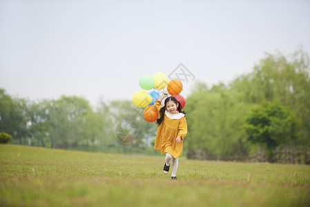 拿着气球开心奔跑的小女孩图片