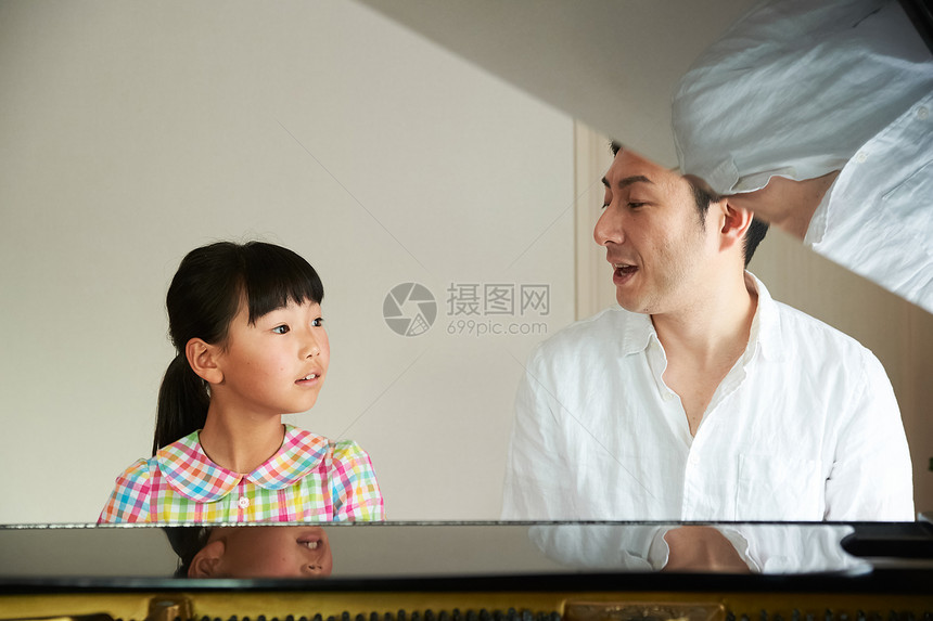 年轻的女孩学习钢琴课图片